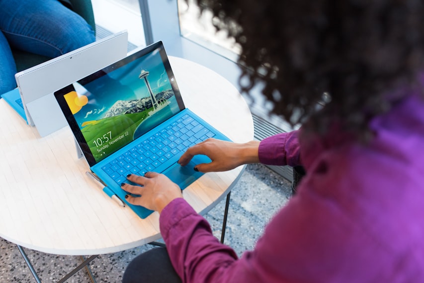 Creator running an AI agent workflow across social platforms on a laptop